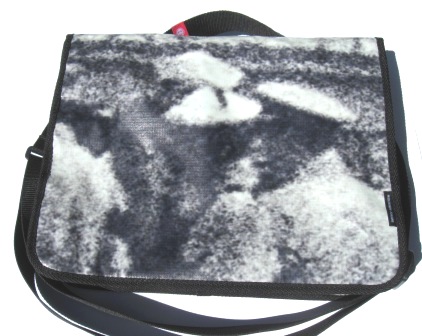 A recycled laptop bag made out of Powershop's Electricity vs Power billboard campaign.